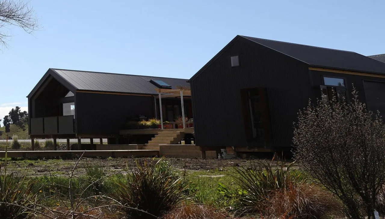 Compact dark-clad gable pavilion, an Ecotectural home in Tasman