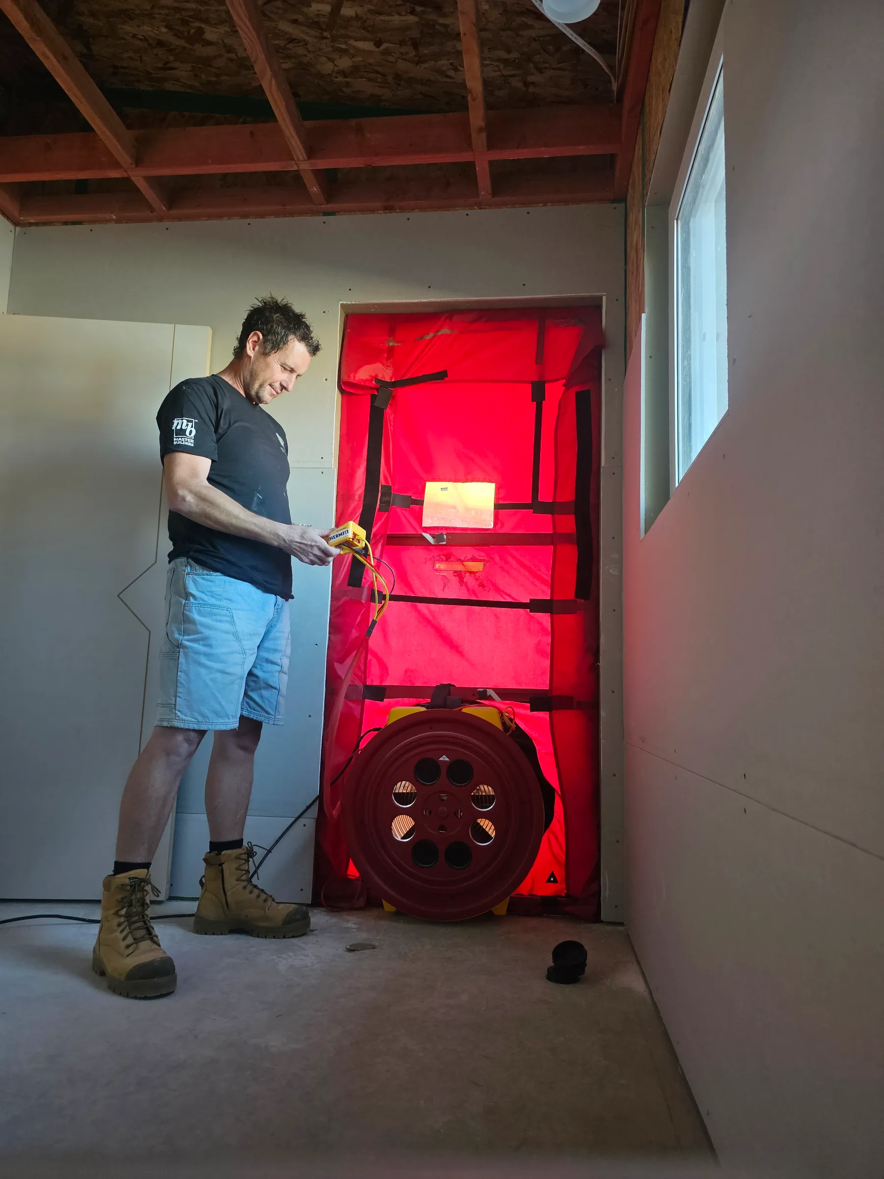 Blower-door airtightness testing on an Ecotectural build