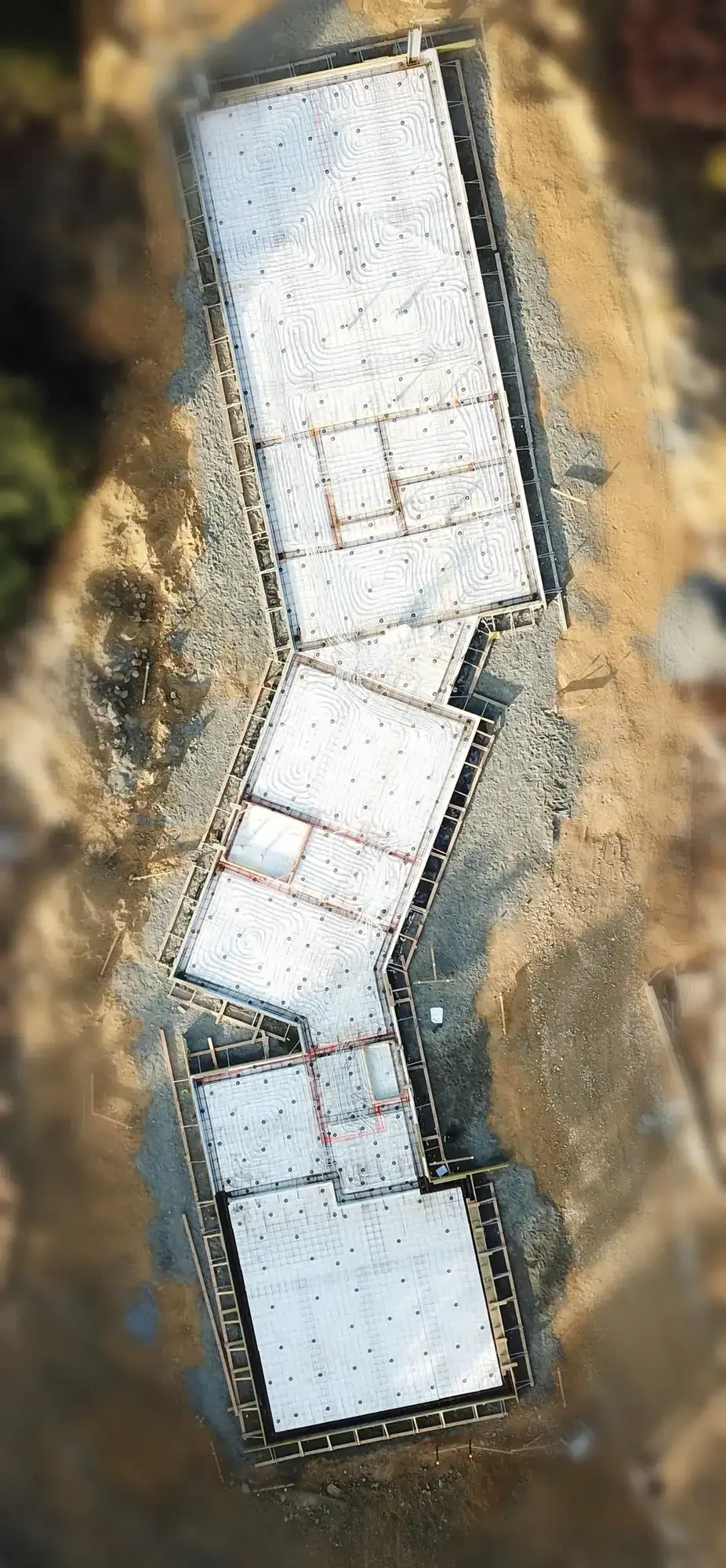 Aerial view of the concrete foundation of an Ecotectural home in Nelson Tasman.