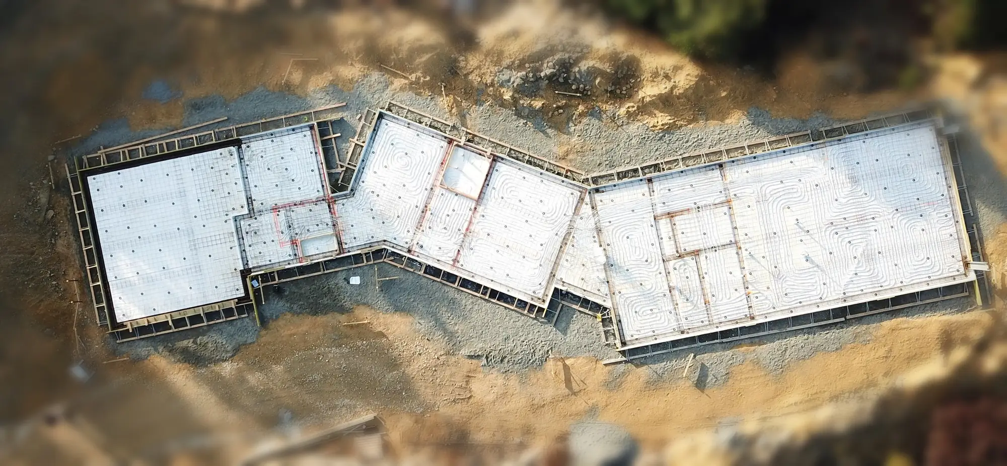 Aerial view of the concrete foundation of an Ecotectural home in Nelson Tasman.