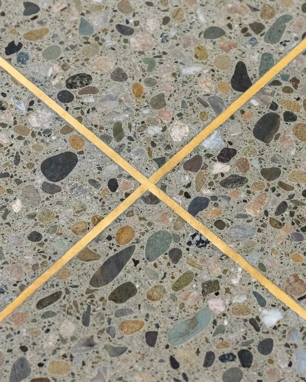 Exposed seeded-aggregate terrazzo floor detail inside The Blue House, Upper Moutere