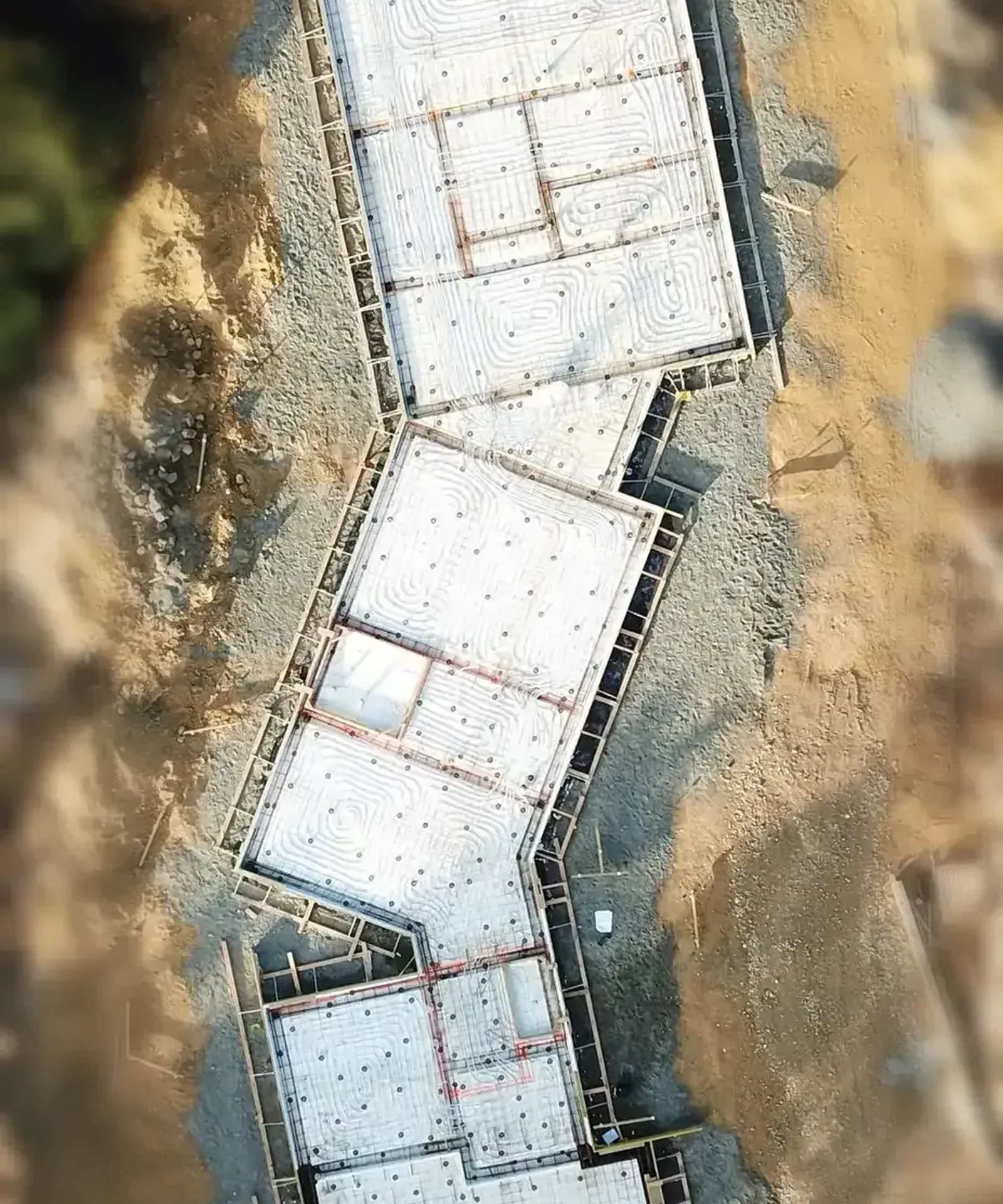 An insulated concrete slab with in-floor heating loops laid out before pouring, Nelson Tasman