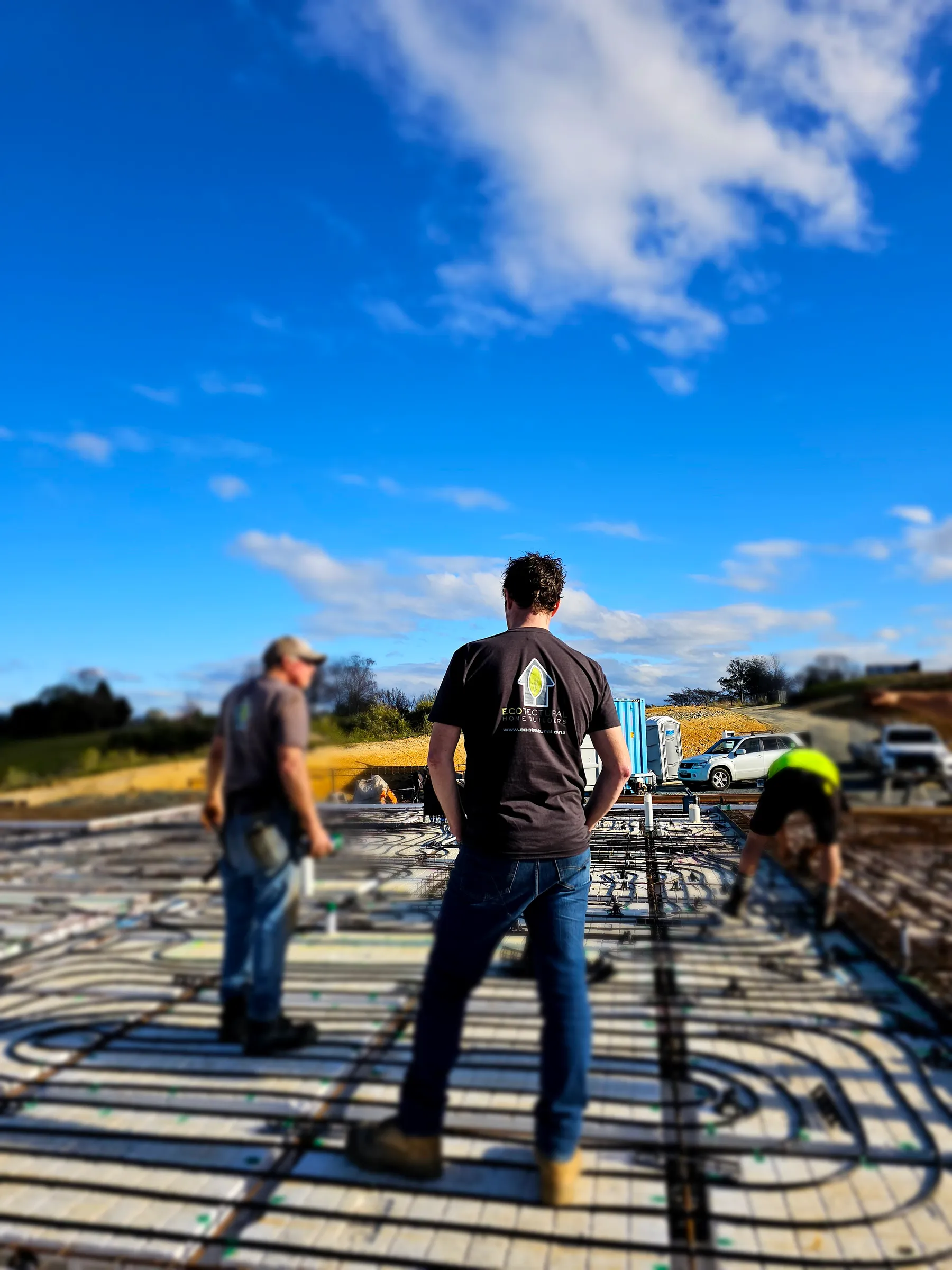 Daryl Combes overseeing the Ecotectural crew on an insulated foundation slab laid with underfloor heating loops, Tasman