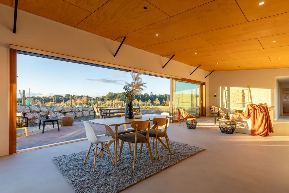 Dining under the timber-lined vaulted ceiling with rural views, Horton Road, Tasman