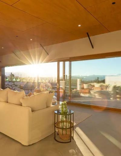 Light-filled living area with its warm timber-lined ceiling at Horton Road, Tasman