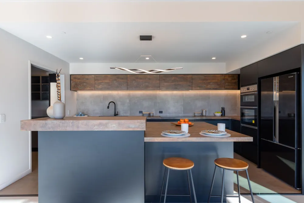 Open-plan kitchen and living under the timber ceiling, Horton Road, Tasman