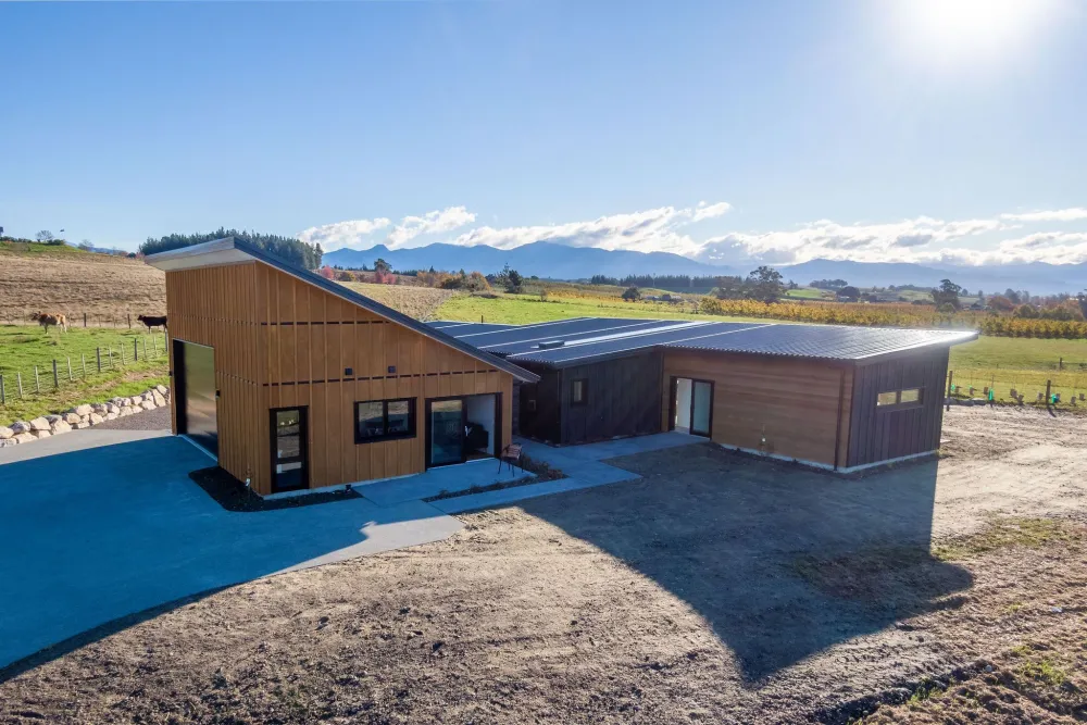 The home and its stone forecourt against the Tasman ranges, Horton Road