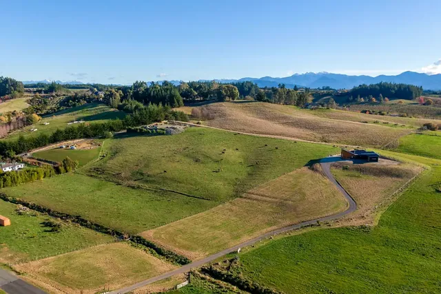 Aerial over Tasman farmland with a dark home in the hills, the Knowledge Centre hero