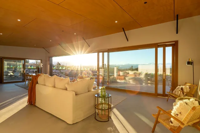 Sunlit living room with a warm timber ceiling at Horton Road, Tasman