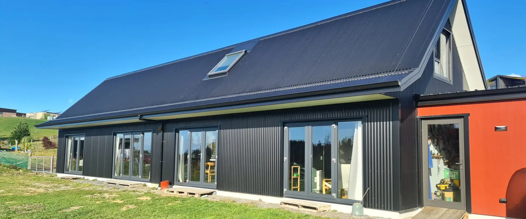 The black long-run corrugate barn-form SIPs home at Martin Conway, Redwood Valley