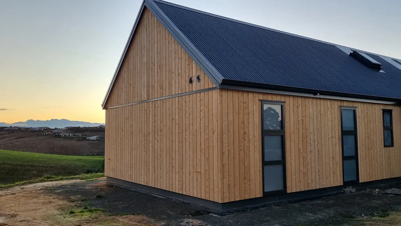 Lawson Cypress shiplap and dark gable roof at dusk, Redwood Valley