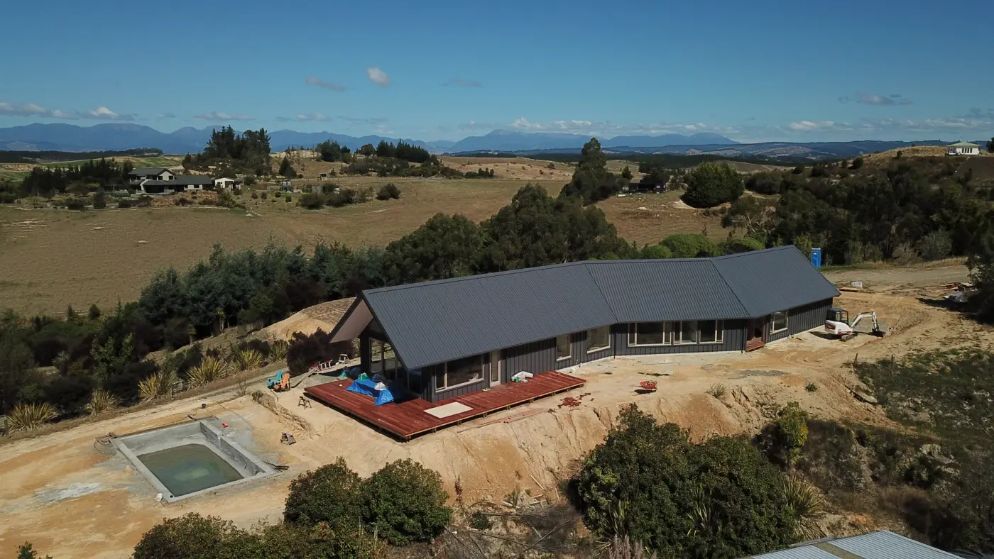 Aerial of Tasman View with its pool terrace, a premium Ecotectural hillside home in Tasman